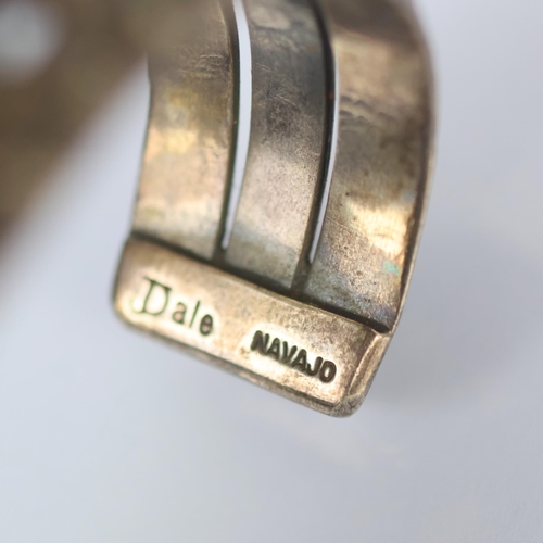 131 - A Navajo lapis lazuli cuff, the seven cabochon lapis lazuli within rub over setting leading to typic... 