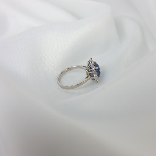 135 - A mid 20th century certified sapphire and diamond cluster ring, circa 1960, the oval sapphire within... 