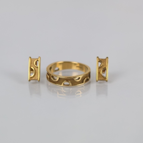137 - A suite of late 20th century yellow metal jewellery, comprising ring and earrings, modelled in an Ar... 
