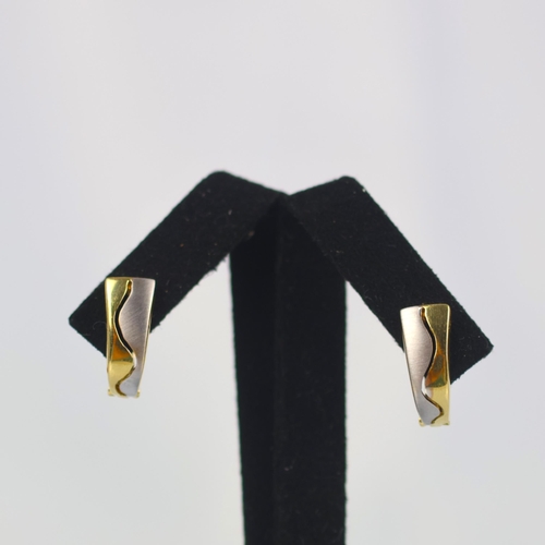 138 - A pair of two tone 'huggie' style earrings, the organically shaped front with curved white and yello... 
