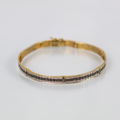 139 - A late 20th century yellow metal diamond bracelet, the wide panelled bracelet set with central row o... 