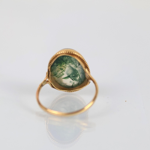 145 - A late 20th century 9ct gold moss agate ring, the oval cabochon moss agate set in rub over mount wit... 