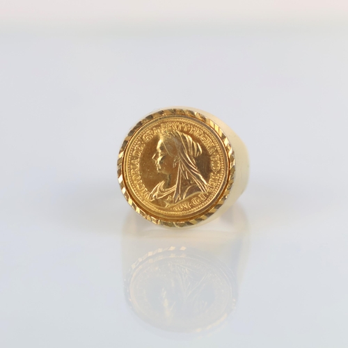153 - A late 20th century gold plated 'coin' ring, the signet style ring set with a 'sovereign' style coin... 