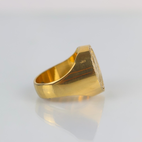 153 - A late 20th century gold plated 'coin' ring, the signet style ring set with a 'sovereign' style coin... 