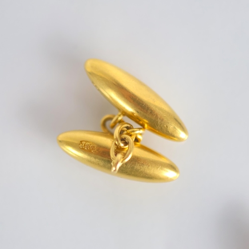155 - A pair of early 20th century yellow metal cufflinks, the torpedo shaped cufflinks with trace link ch... 