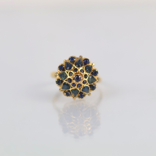 158 - A late 20th century 'Thai princess ring' the raised head set with various cuts of sapphires, with fa... 