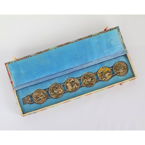 160 - A mid 20th century Japanese Shakudo bracelet, the six circular panels depicting scenes of cranes amo... 