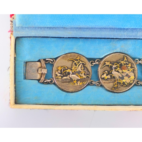 160 - A mid 20th century Japanese Shakudo bracelet, the six circular panels depicting scenes of cranes amo... 