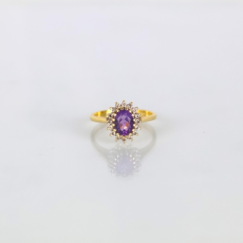 161 - A late 20th century 18ct yellow gold amethyst ring, the central oval cut amethyst within diamond sur... 