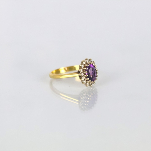 161 - A late 20th century 18ct yellow gold amethyst ring, the central oval cut amethyst within diamond sur... 