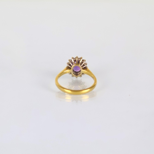 161 - A late 20th century 18ct yellow gold amethyst ring, the central oval cut amethyst within diamond sur... 