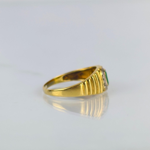 162 - A late 20th century emerald and diamond ring, the central oval cut emerald within surround of round ... 