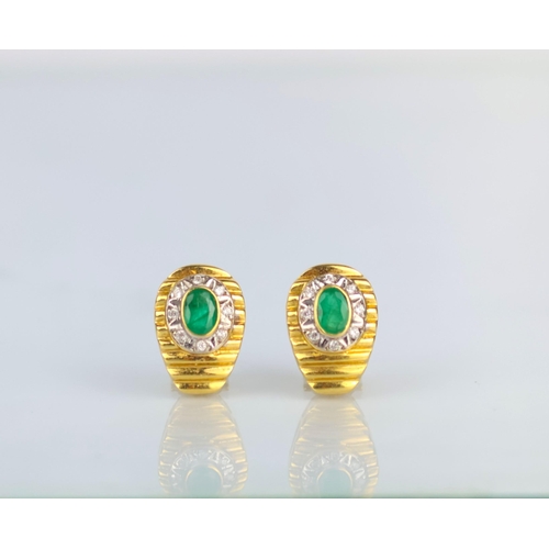 163 - A pair of late 20th century emerald and diamond earrings, the oval cut emeralds within border of eig... 