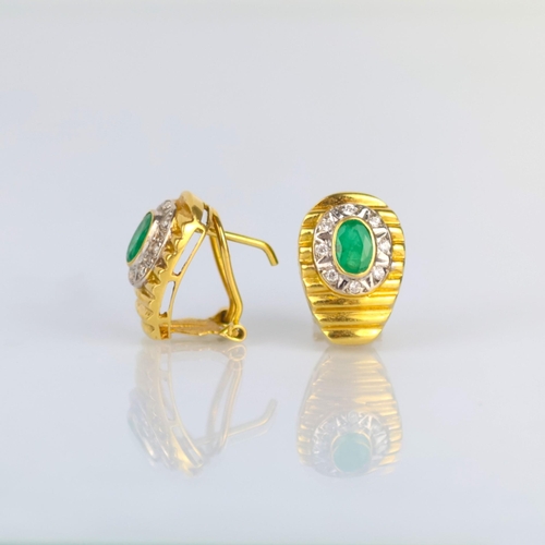 163 - A pair of late 20th century emerald and diamond earrings, the oval cut emeralds within border of eig... 