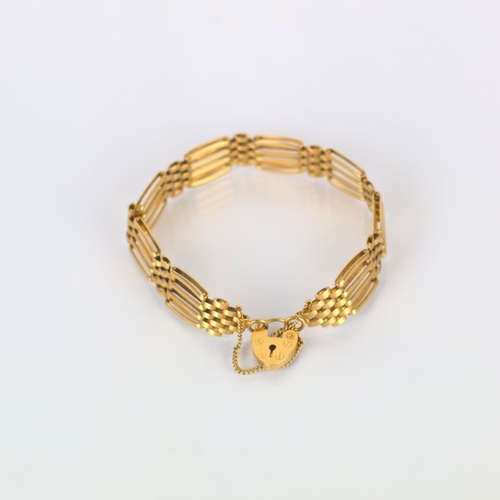 166 - A late 20th century style 9ct gold bracelet, the oval shaped gate link bracelet suspending a heart s... 