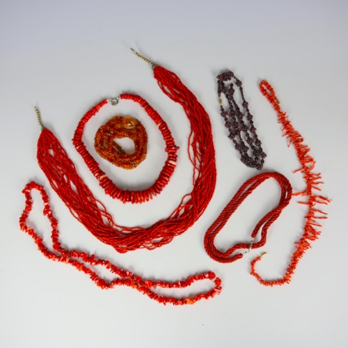170 - A selection of beads, including a strand of coral, of stylised fringe design, 50cm long, two further... 