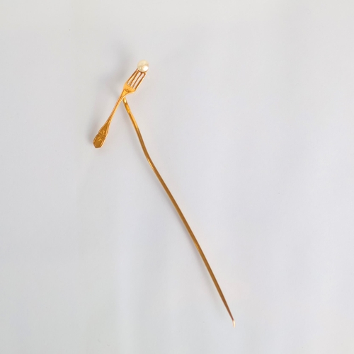 173 - A French novelty stick pin, the terminal modelled as a fork with seed pearl ‘morsel’ stamped with ea... 