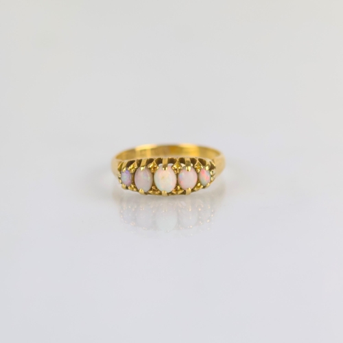176 - An early 20th century opal five stone ring, the five graduated oval opal cabochons within claw setti... 