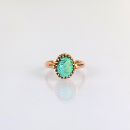 177 - An early 20th century turquoise dress ring, the organically shaped turquoise within a yellow metal c... 