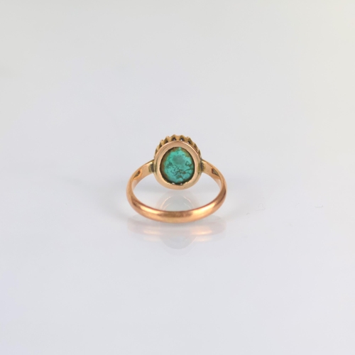 177 - An early 20th century turquoise dress ring, the organically shaped turquoise within a yellow metal c... 