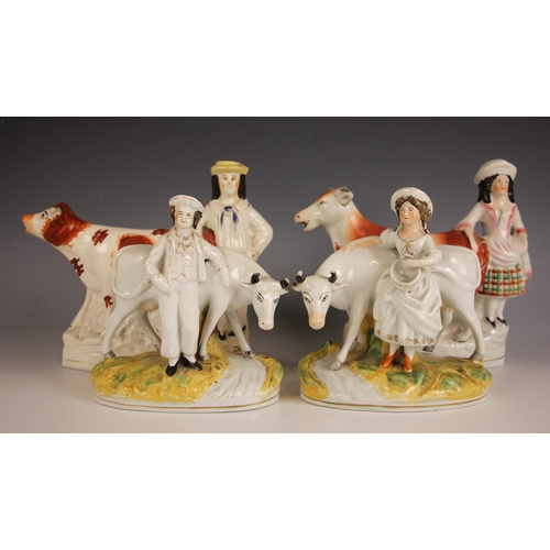 306 - A pair of Victorian Staffordshire cow creamers, mid 19th century, one modelled with a cowherd, the o... 