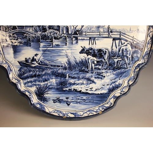 309 - A Tichelaar Makkum Delft blue and white wall plaque, 20th century, of shaped oval form with raised r... 