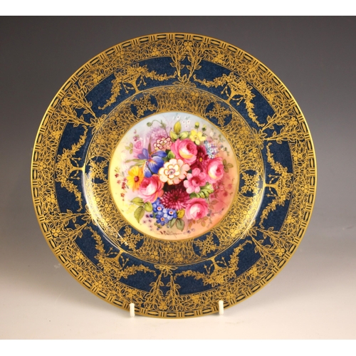 314 - A Royal Worcester cabinet plate decorated by E. Phillips, early 20th century, the well profusely han... 