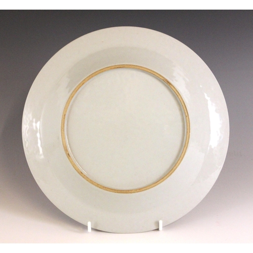 334 - A Chinese porcelain famille rose plate, 18th century style, the shallow circular plate painted to th... 