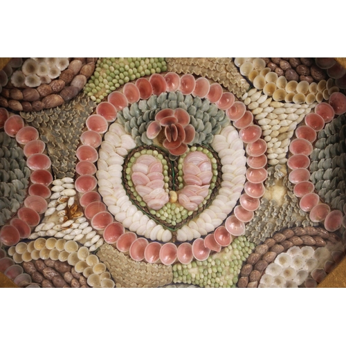 369 - A Victorian sailor's shellwork valentine or love token, late 19th century, modelled with a central h... 