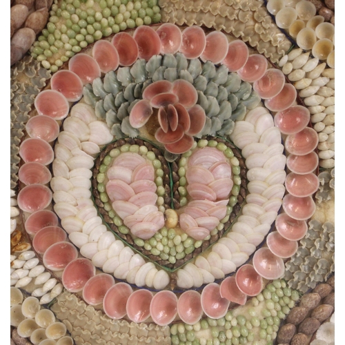 369 - A Victorian sailor's shellwork valentine or love token, late 19th century, modelled with a central h... 