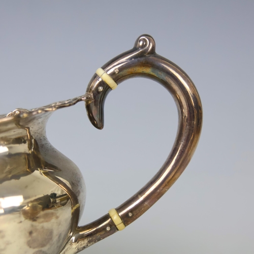 40 - An Edwardian silver three piece tea service, John Alexander Fettes, Glasgow 1901, comprising teapot,... 