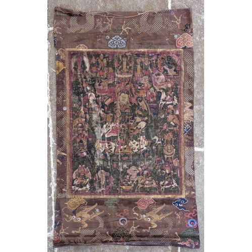 415 - A South East Asian Tibetan Thangka, 19th century, painted in gouache against a silk and metallic gro... 