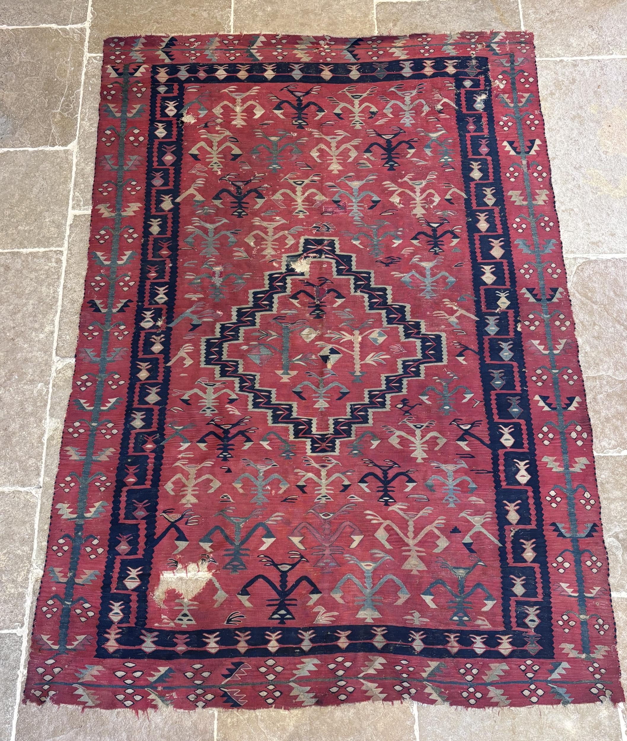 A hand knotted Turkish Kilim rug, with a central geometric diamond ...
