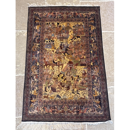 476 - A Persian Tabriz pictorial silk rug, the central field decorated with processions of warriors and ku... 