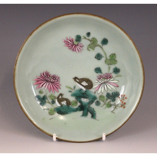 348 - A Chinese celadon-ground famille rose dish, 19th century, of circular form and panted to the centre ... 