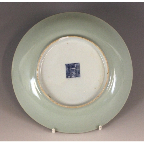 348 - A Chinese celadon-ground famille rose dish, 19th century, of circular form and panted to the centre ... 