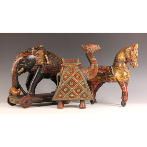 320 - A collection of Indian and South East Asian carvings, 20th century, to include an elephant, a horse,... 