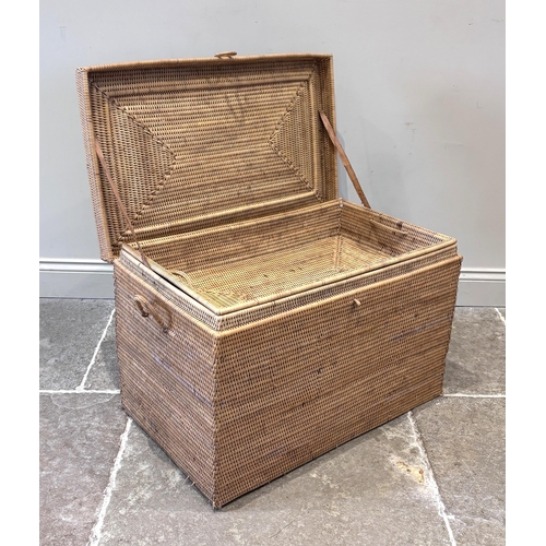 596 - An Anglo-Indian wicker campaign picnic hamper, circa 1910, of rectangular form, the hinged lid openi... 