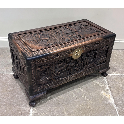 597 - An early 20th century Chinese carved hardwood blanket chest, the rectangular chest carved in high re... 