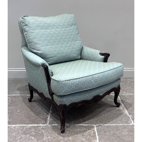 575 - A Louis XV style carved walnut fauteuil, upholstered in a green and gold trellis design fabric, with... 