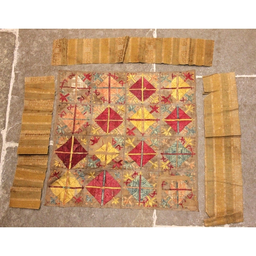 409 - An Indian gauze bandhani sari panel, embroidered with repeating geometric gulls against a red ground... 