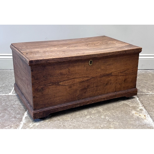 548 - A George III oak carriage or blanket box, of rectangular form, the hinged cover above an oval brass ... 