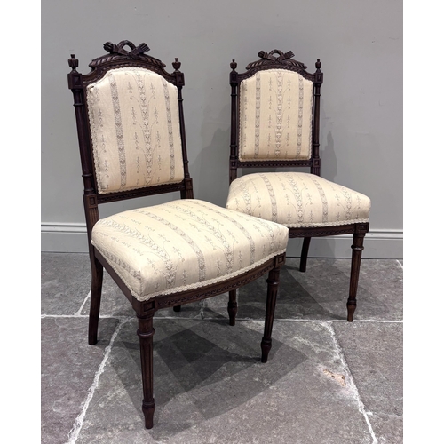 555 - A pair of Louis XVI style walnut side chairs, circa 1880, the carved frames with torch and quiver ra... 