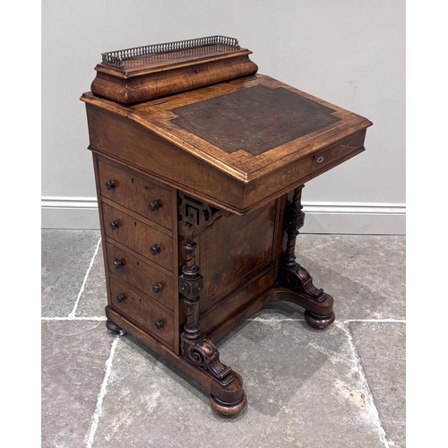 559 - A Victorian walnut and inlaid Davenport, the leather skiver inset slope, below a stationery box with... 