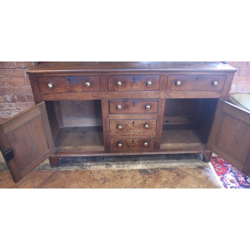 551A - A George III oak dresser, probably Conwy Valley, the moulded cornice above a plain frieze applied wi... 