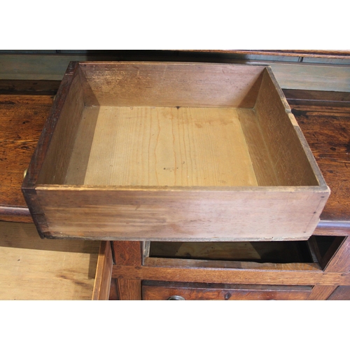 551A - A George III oak dresser, probably Conwy Valley, the moulded cornice above a plain frieze applied wi... 