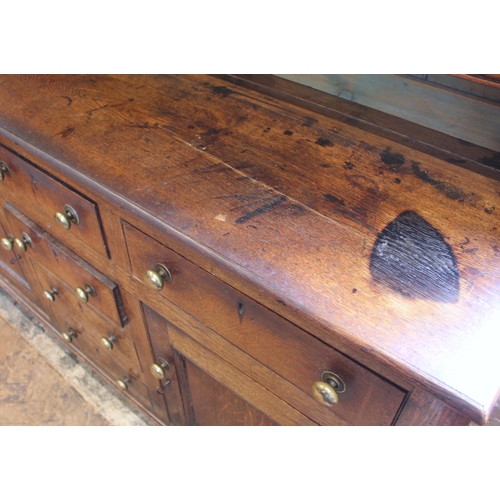 551A - A George III oak dresser, probably Conwy Valley, the moulded cornice above a plain frieze applied wi... 