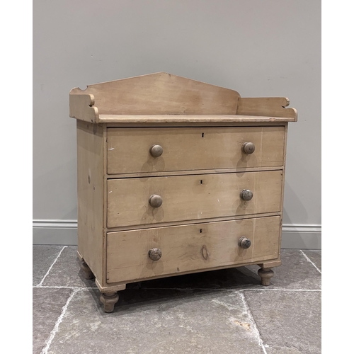 569 - A pine chest of drawers, late 19th century, the rectangular three-quarter galleried top above three ... 