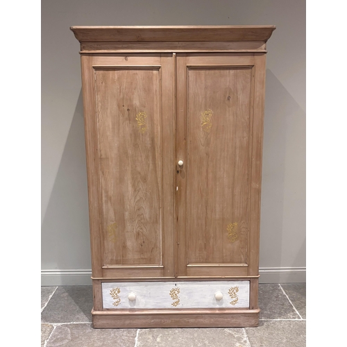 580 - A Victorian pine double wardrobe, the detachable cornice above a pair of cupboard doors enclosing pe... 