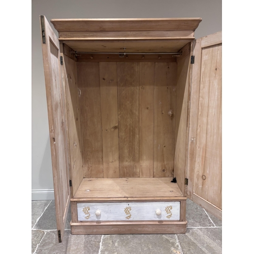 580 - A Victorian pine double wardrobe, the detachable cornice above a pair of cupboard doors enclosing pe... 